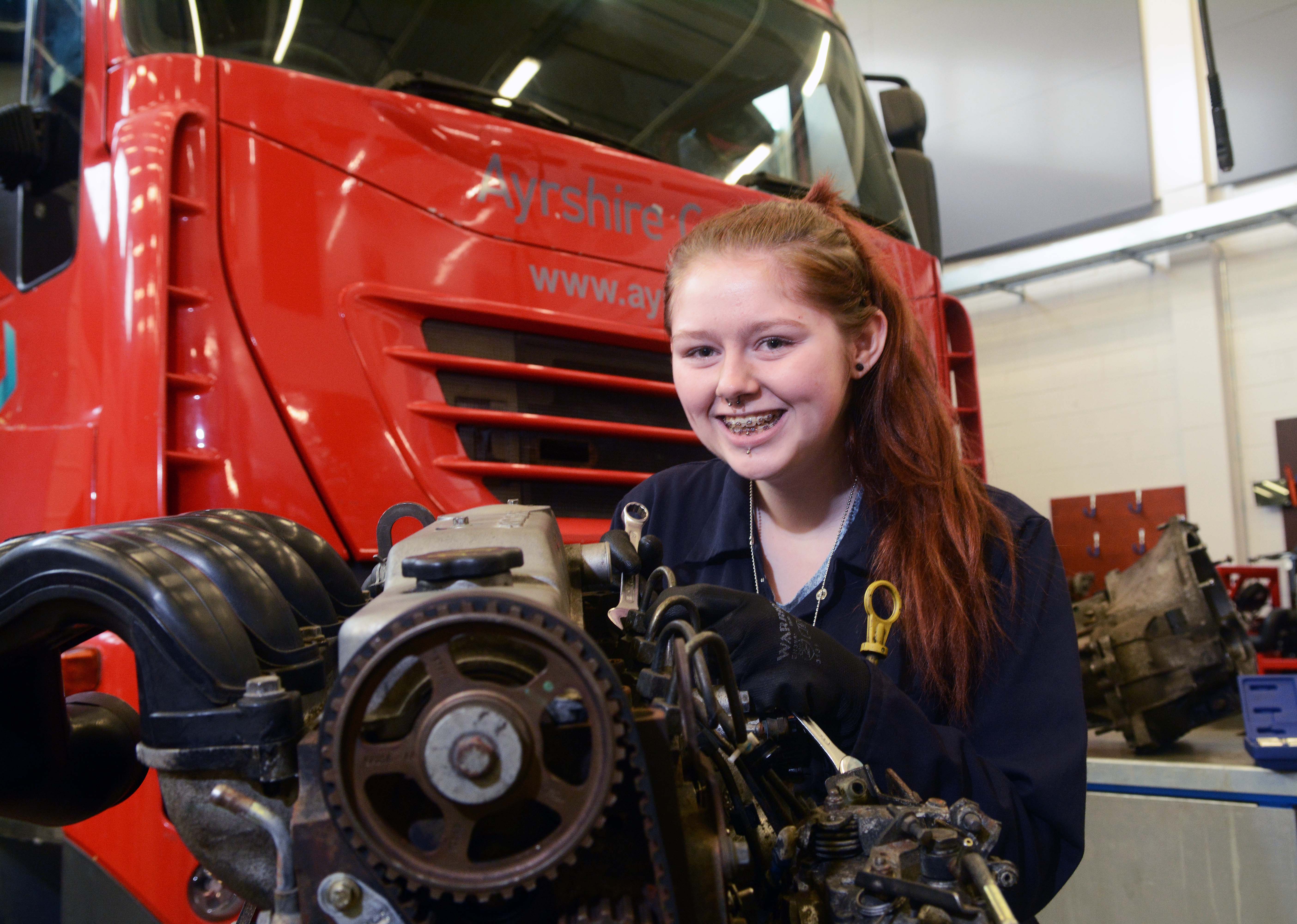 Motoring ahead with Ayrshire College.girl with braces with engine.jpg