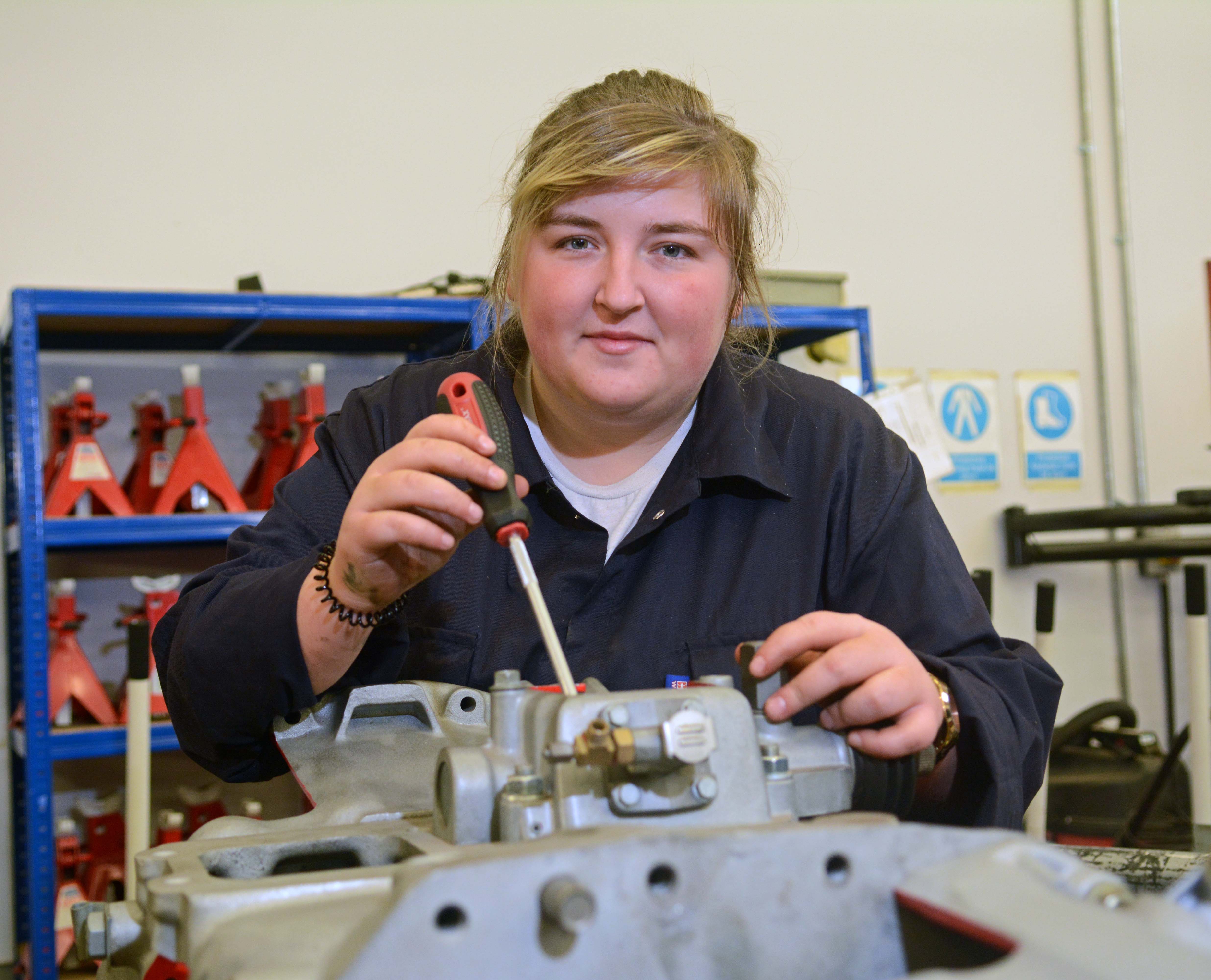 Motoring ahead with Ayrshire College.girl with engine.jpg